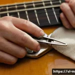 Home 21 기타 브릿지 핀 제거법 - A close-up scene of a person carefully using thin-nose pliers wrapped with a soft cloth to gently pu...