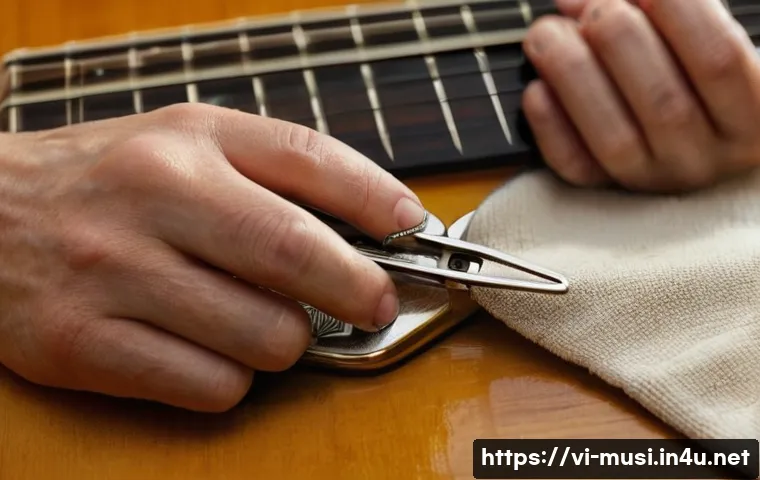 기타 브릿지 핀 제거법 - A close-up scene of a person carefully using thin-nose pliers wrapped with a soft cloth to gently pu...